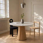 Load image into Gallery viewer, Modern Round Dining Table with Walnut Veneer Top & Travertine-Inspired Pedestal Base