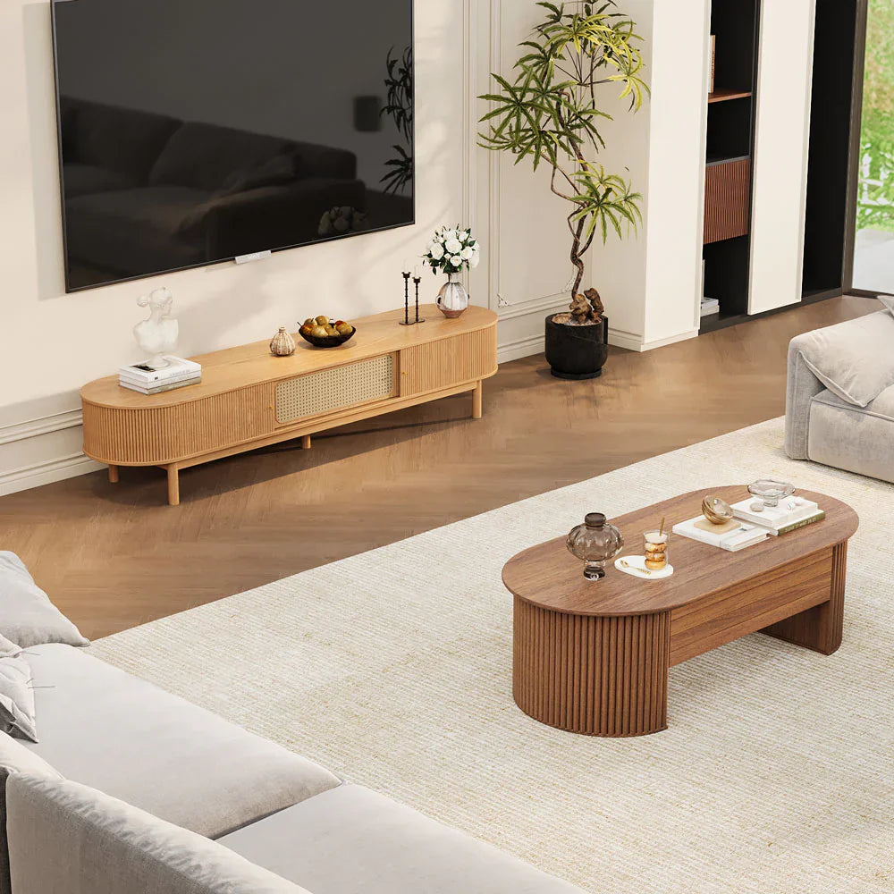 Modern living room styled with a fluted wood TV stand and matching oval coffee table, featuring warm wood tones, minimalist decor, and a balanced layout that highlights contemporary furniture design.