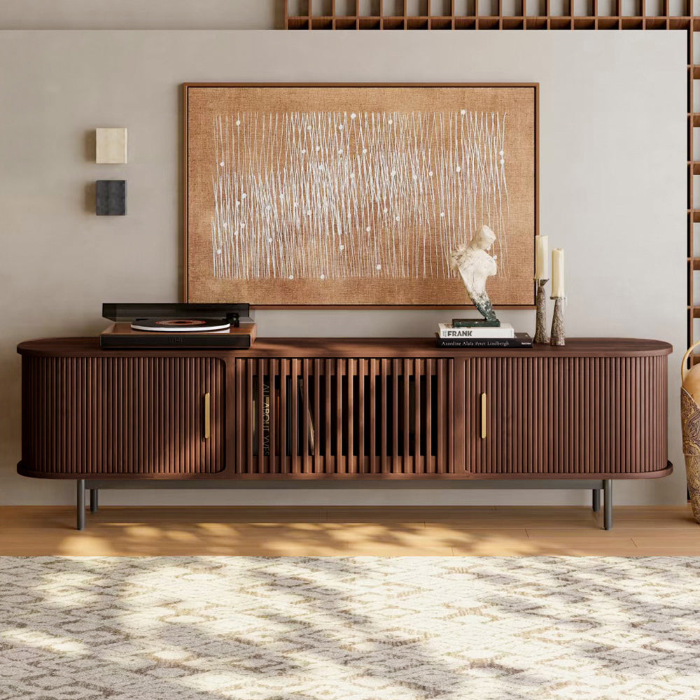 Wooden entertainment console with decorative items in a living room setting