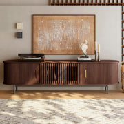 Wooden entertainment console with decorative items in a living room setting