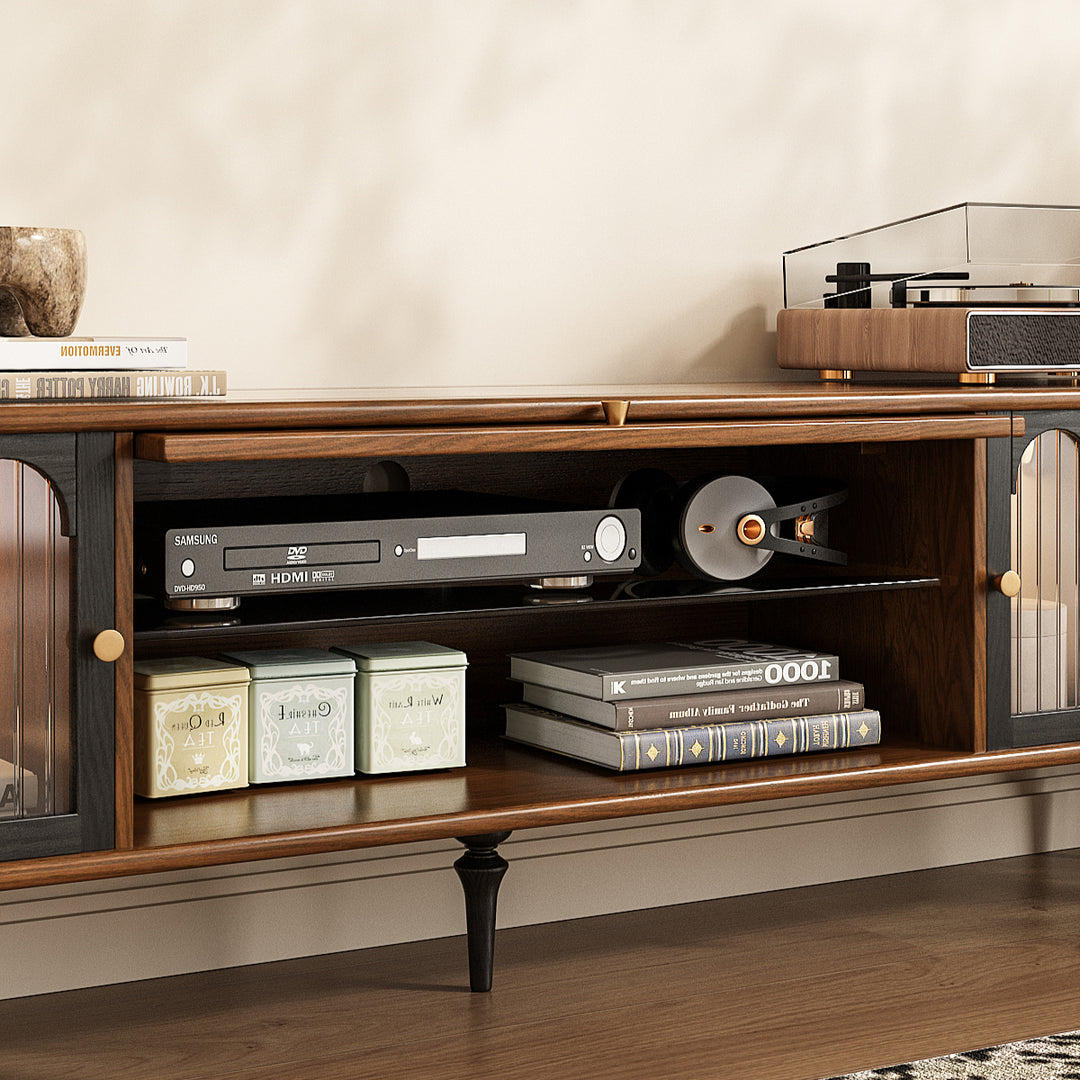Wooden entertainment console with electronic devices and books on a neutral background