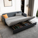 Load image into Gallery viewer, Gray velvet sofa bed with pull-out mechanism in a room with curtains and a rug.
