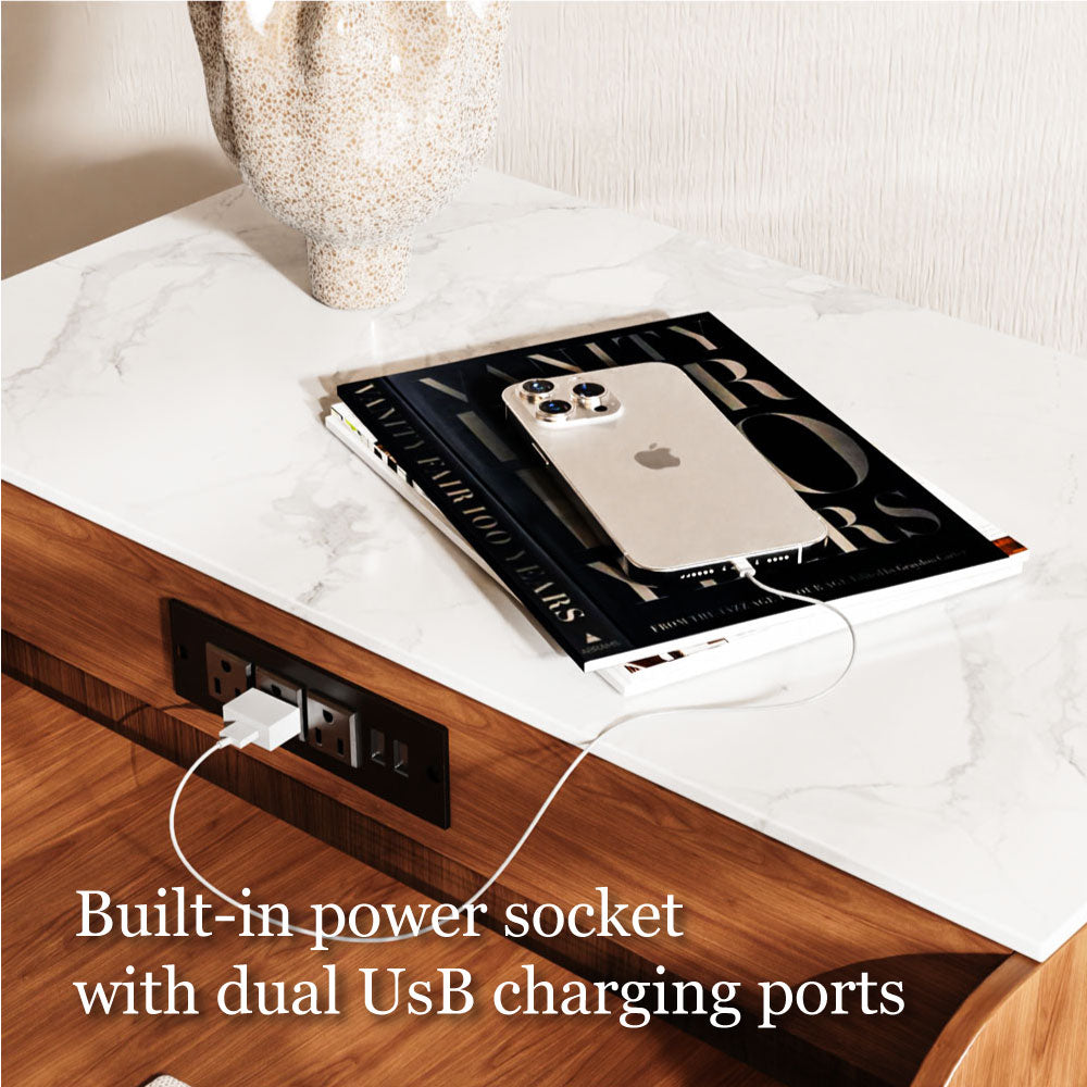 Table with a phone on it, connected to a power outlet with text 'Built-in power socket with dual USB charging ports'.