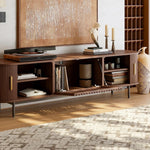 Load image into Gallery viewer, Walnut tv stand with sliding side doors and flip-down center door opening in a room with a rug and wall art.
