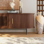 Load image into Gallery viewer, Wooden fluted tv stand with decorative items in a room setting
