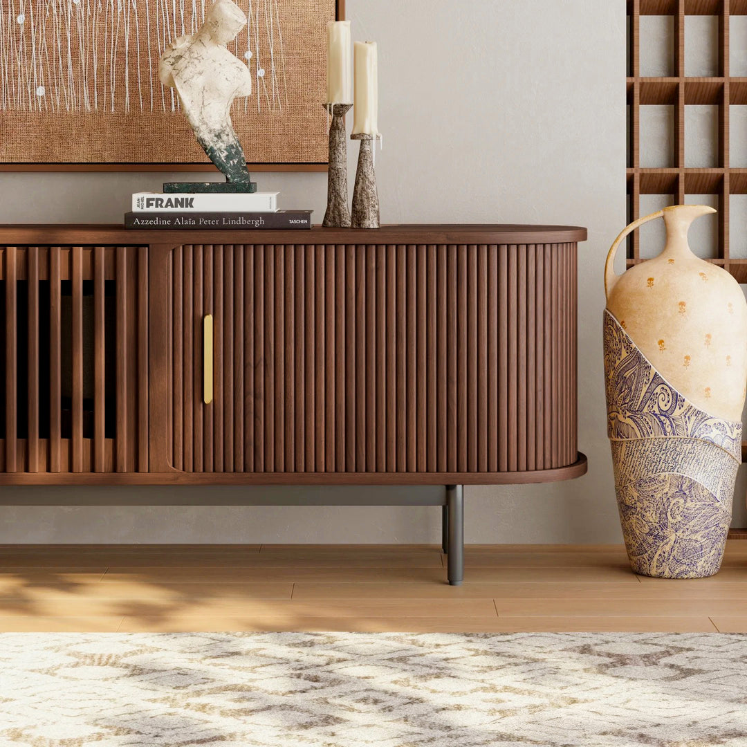 Wooden fluted tv stand with decorative items in a room setting