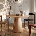 Load image into Gallery viewer, Modern Round Dining Table with Walnut Veneer Top &amp; Travertine-Inspired Pedestal Base
